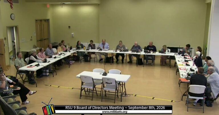 board members sit around a u-shaped table.