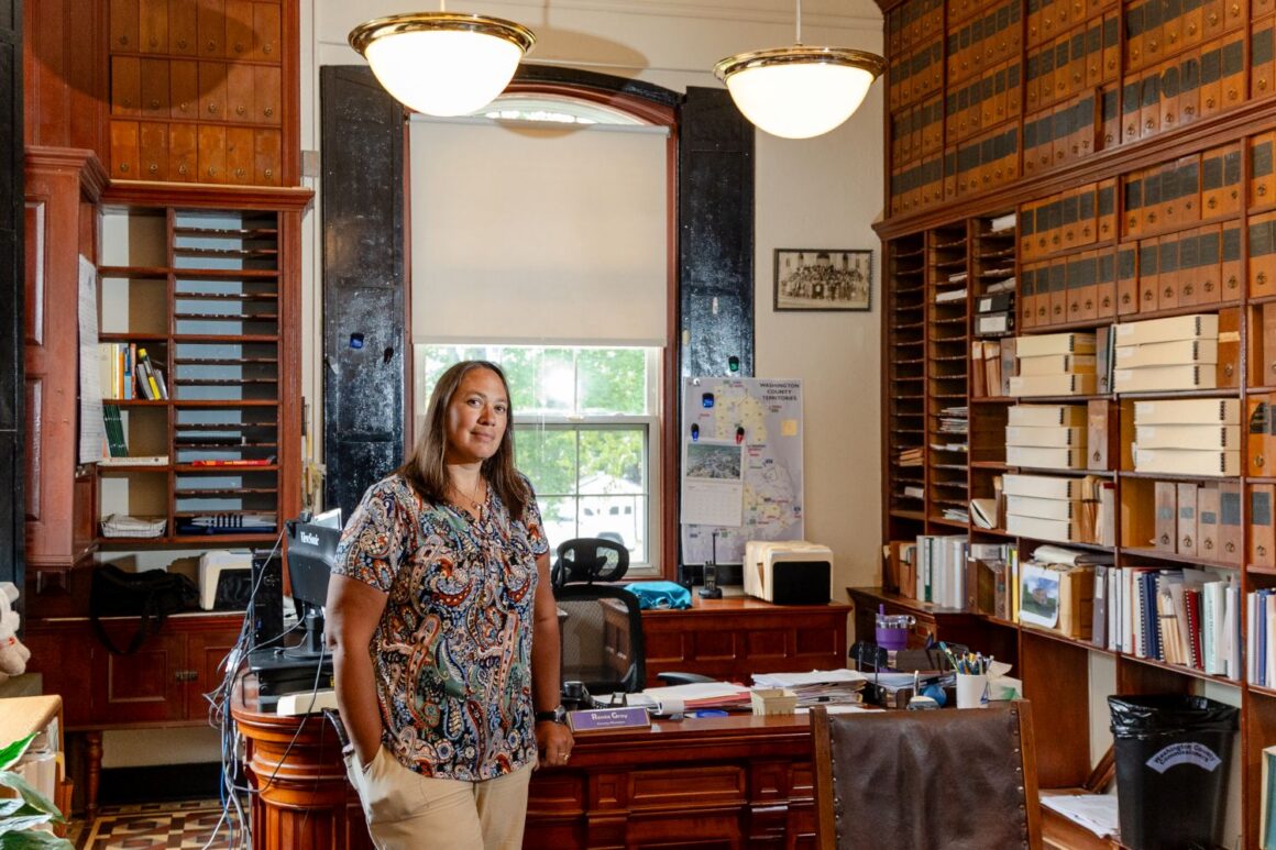 Renée Gray poses for a photo in her office
