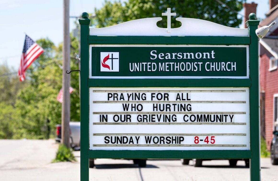 A church sign that reads praying for all who are hurting in our grieving community.