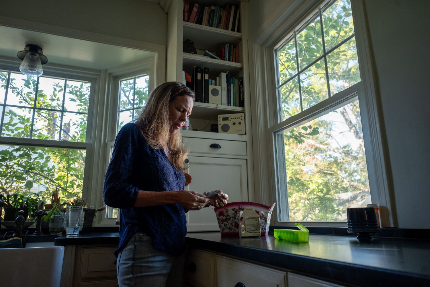 Tracey Collins examining an item in her hands.