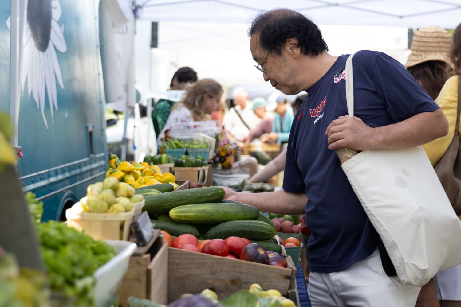 A man browses a selection of fruits and vegetables.