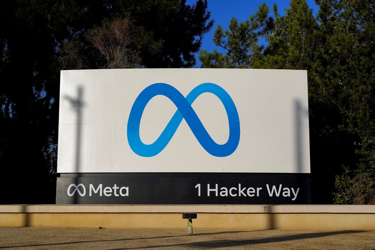 Meta's logo on a large sign at the entrance to its headquarters.