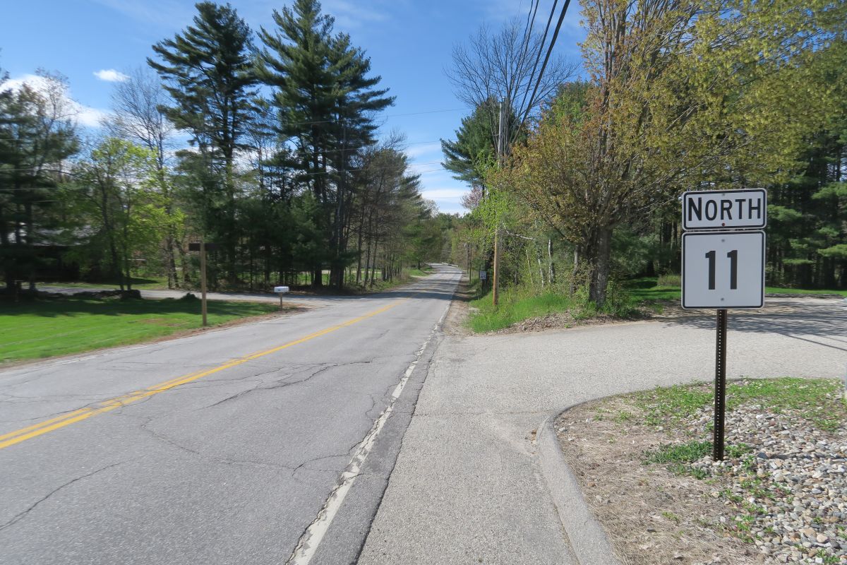 a route 11 sign is seen along an empty road.