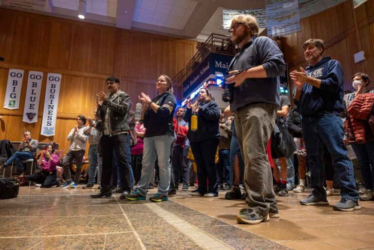 people clapping during a rally