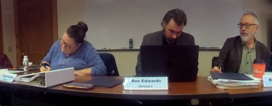 washington county budget advisory members sit around a table during a meeting.
