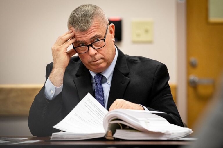 Christopher Wainwright listens to a speaker (not pictured)